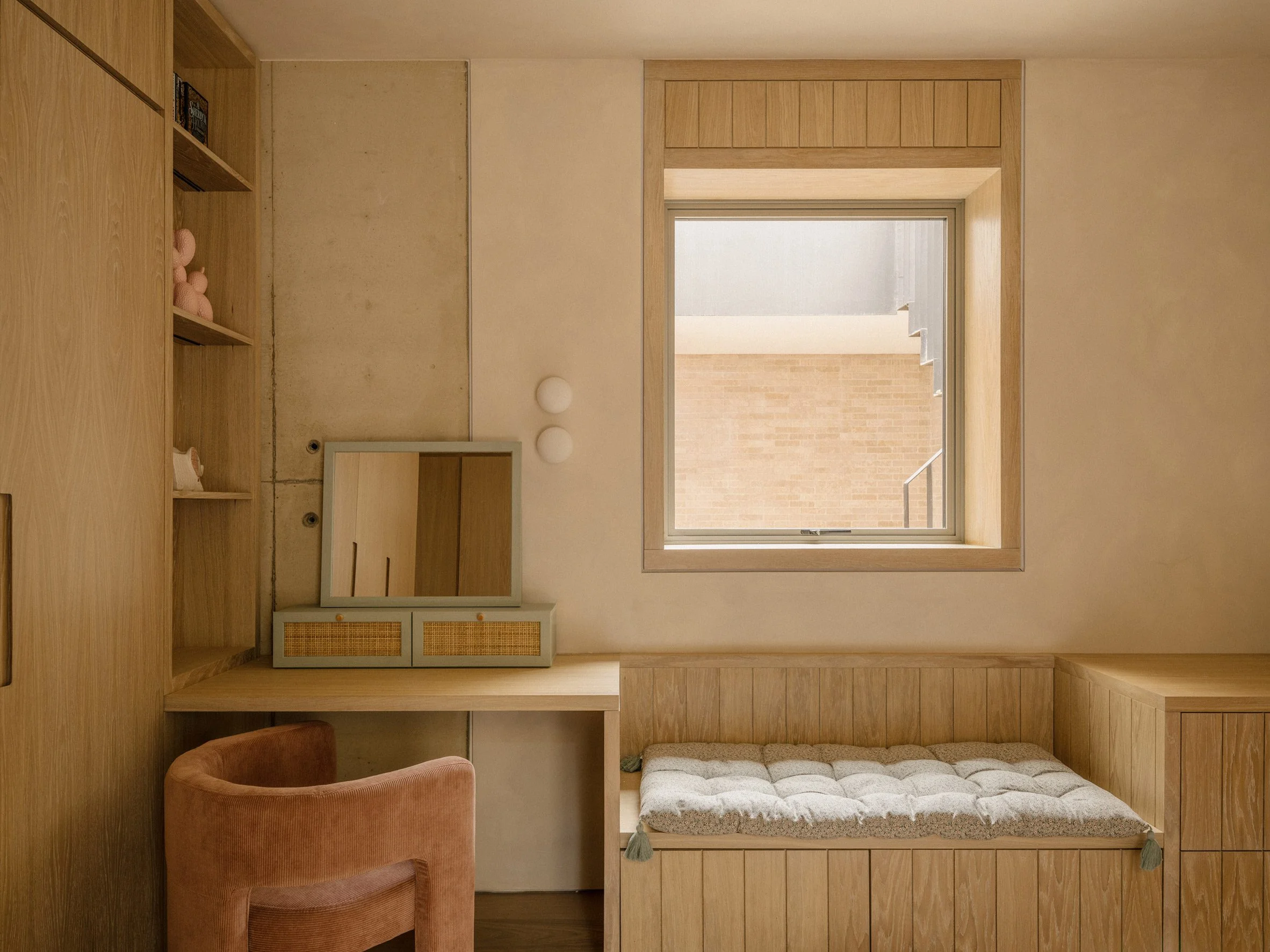 Bedroom with integrated oak desk, storage and window seat overlooking a lightwell