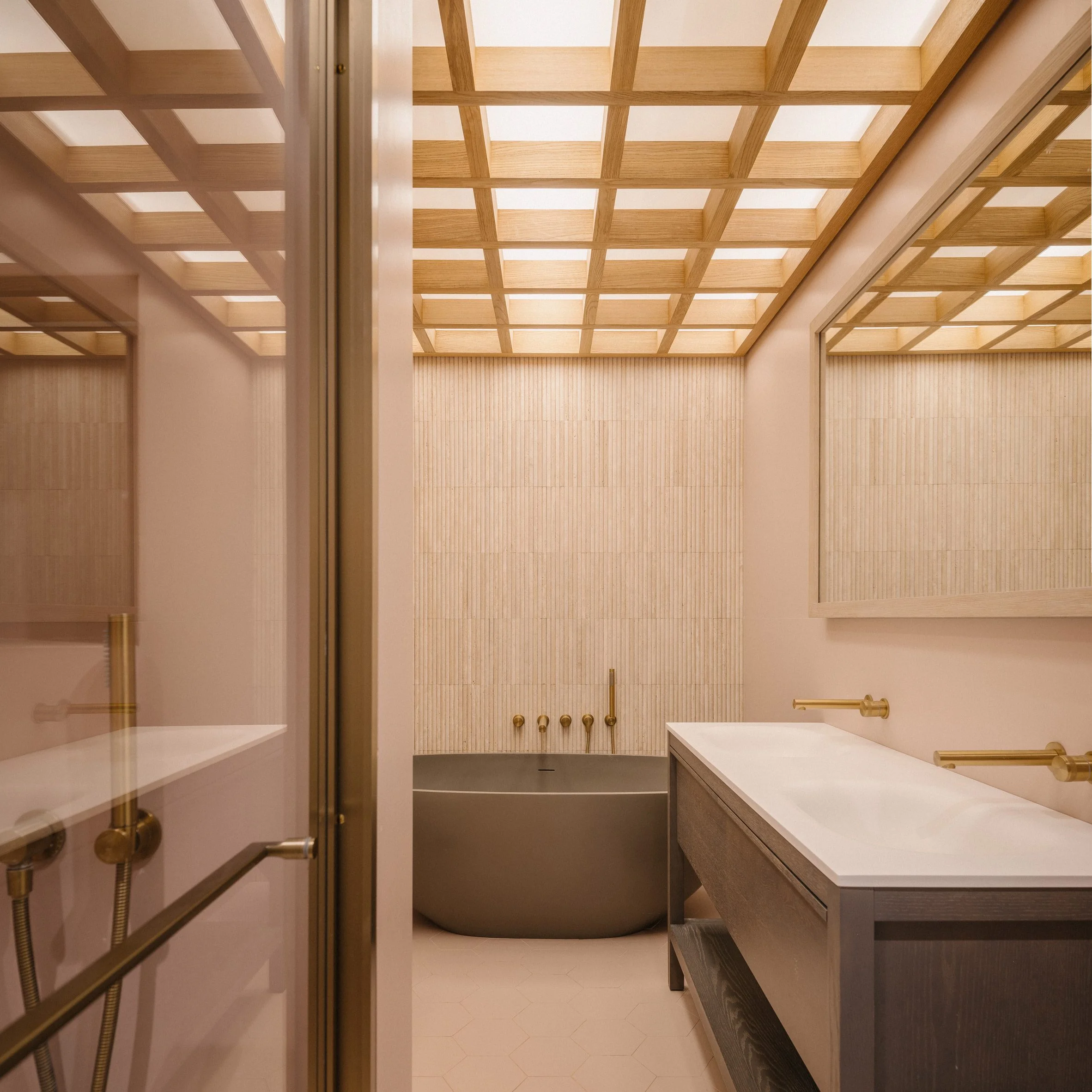 Bathroom featuring a freestanding bath and timber ceiling detailing