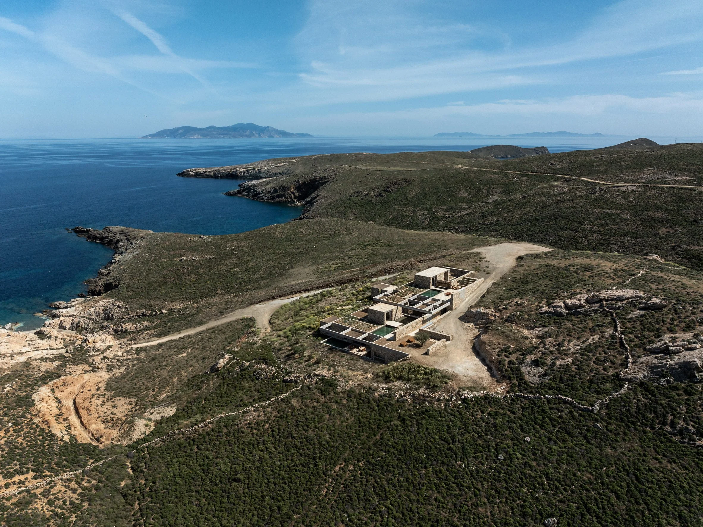 Aerial view of Perma hospitality retreat on a coastal hillside overlooking the Aegean Sea